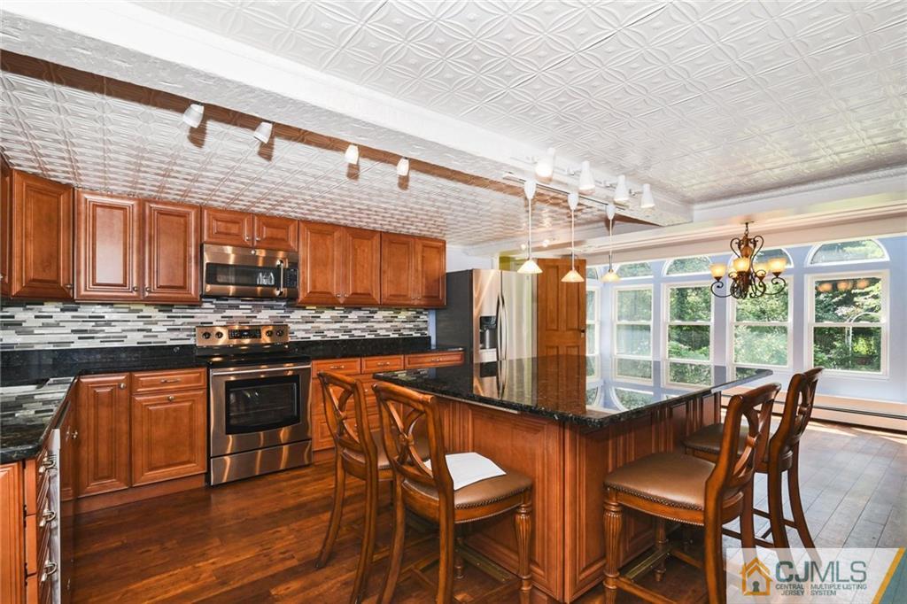 59 Spring Hill Road Old Bridge, NJ 07747 - Photo 4 of 24 a view of a dining room with furniture and wooden floor