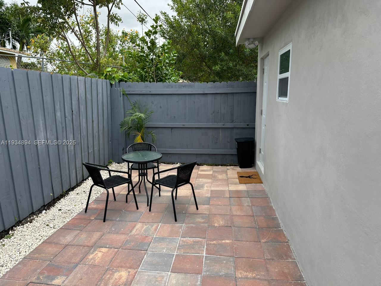 1822 Northwest 4th Street, Unit C Miami, FL 33125 - Photo 7 of 7 a balcony with table and chairs
