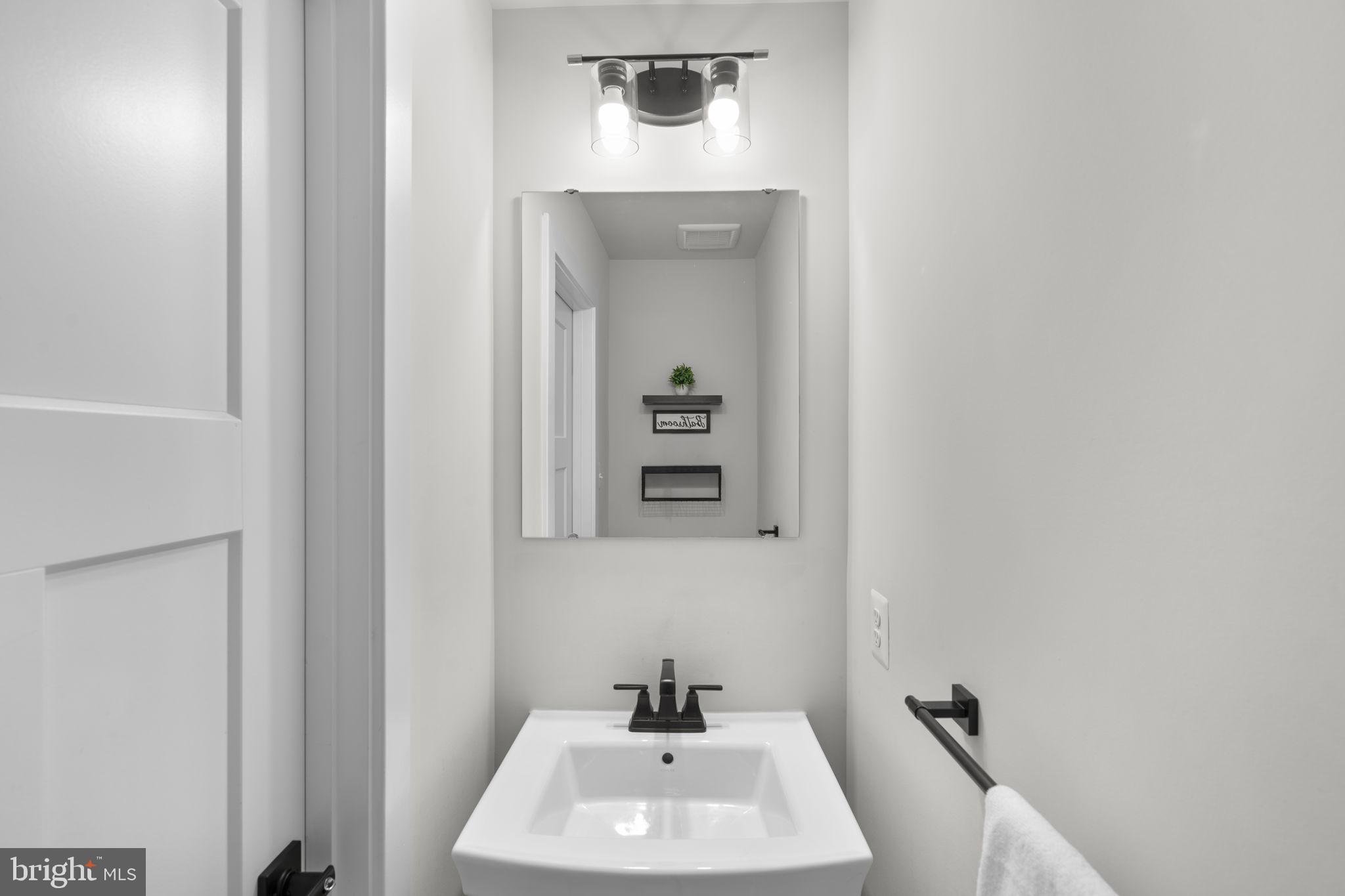 1713 Aurora Way Frederick, MD 21702 - Photo 26 of 57 a bathroom with a sink and mirror