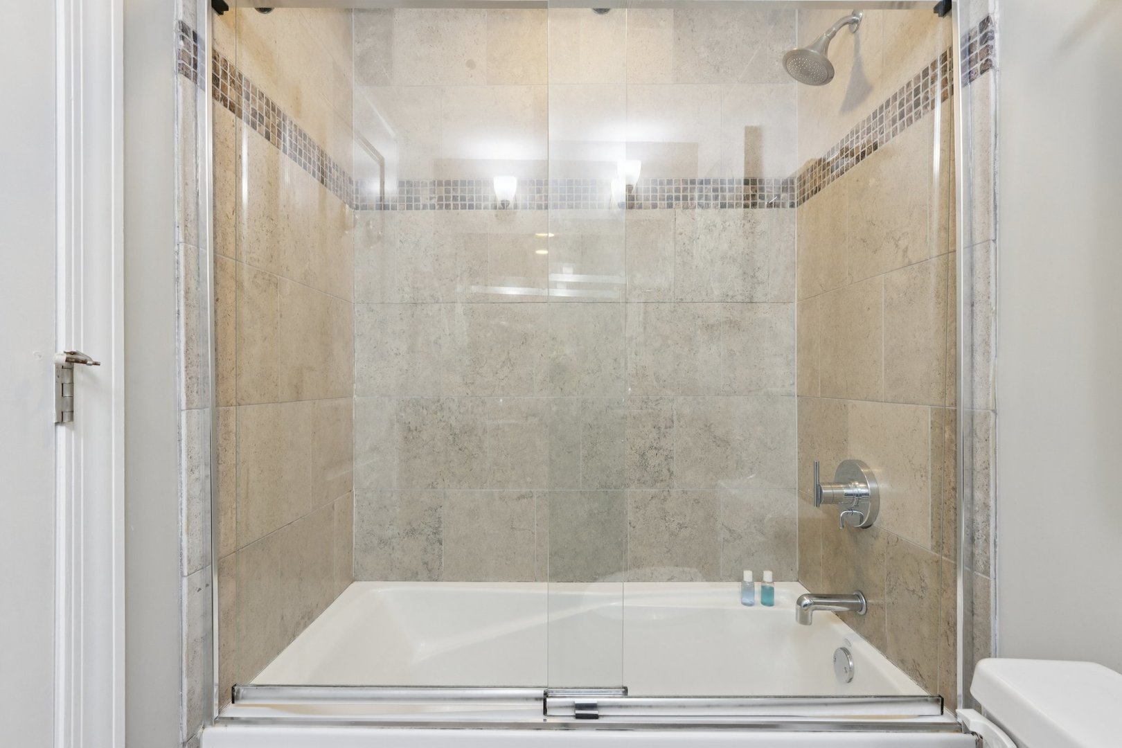 3733 North Damen Avenue, Unit 1 Chicago, IL 60613 - Photo 12 of 14 a bathroom with a tub and shower