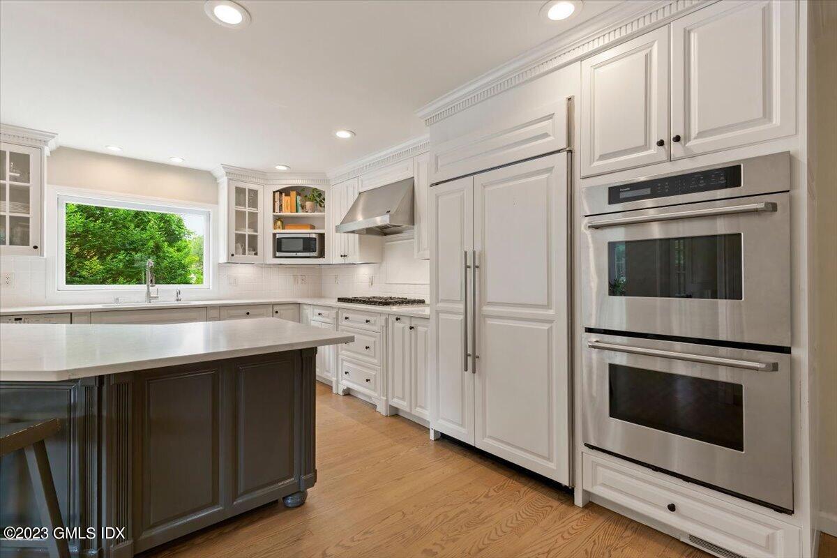 5 Sunshine Avenue Riverside, CT 06878 - Photo 13 of 35 a kitchen with stainless steel appliances granite countertop white cabinets and window