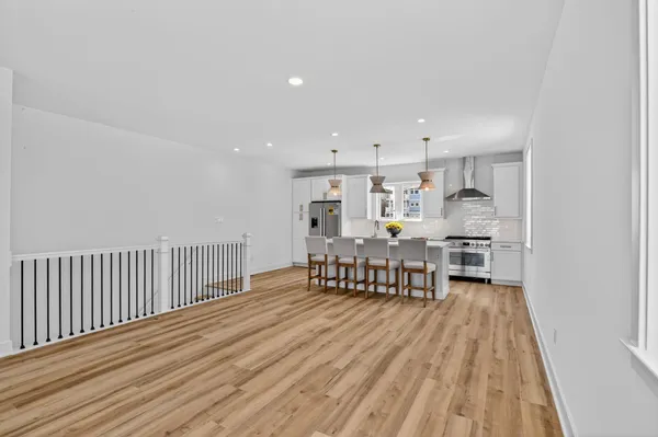 a view of a kitchen with dining room and wooden floor