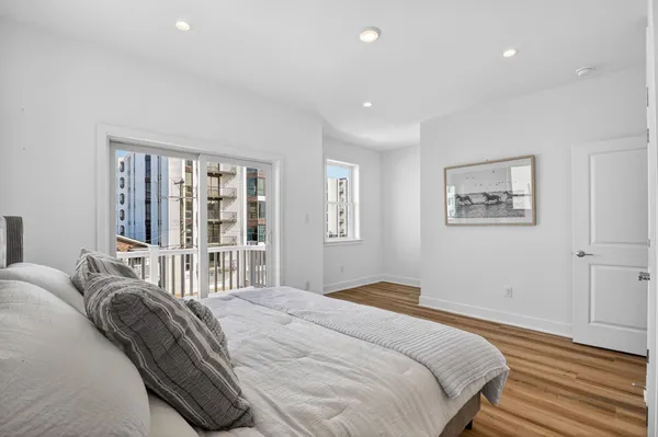a bedroom with a large bed and a large window