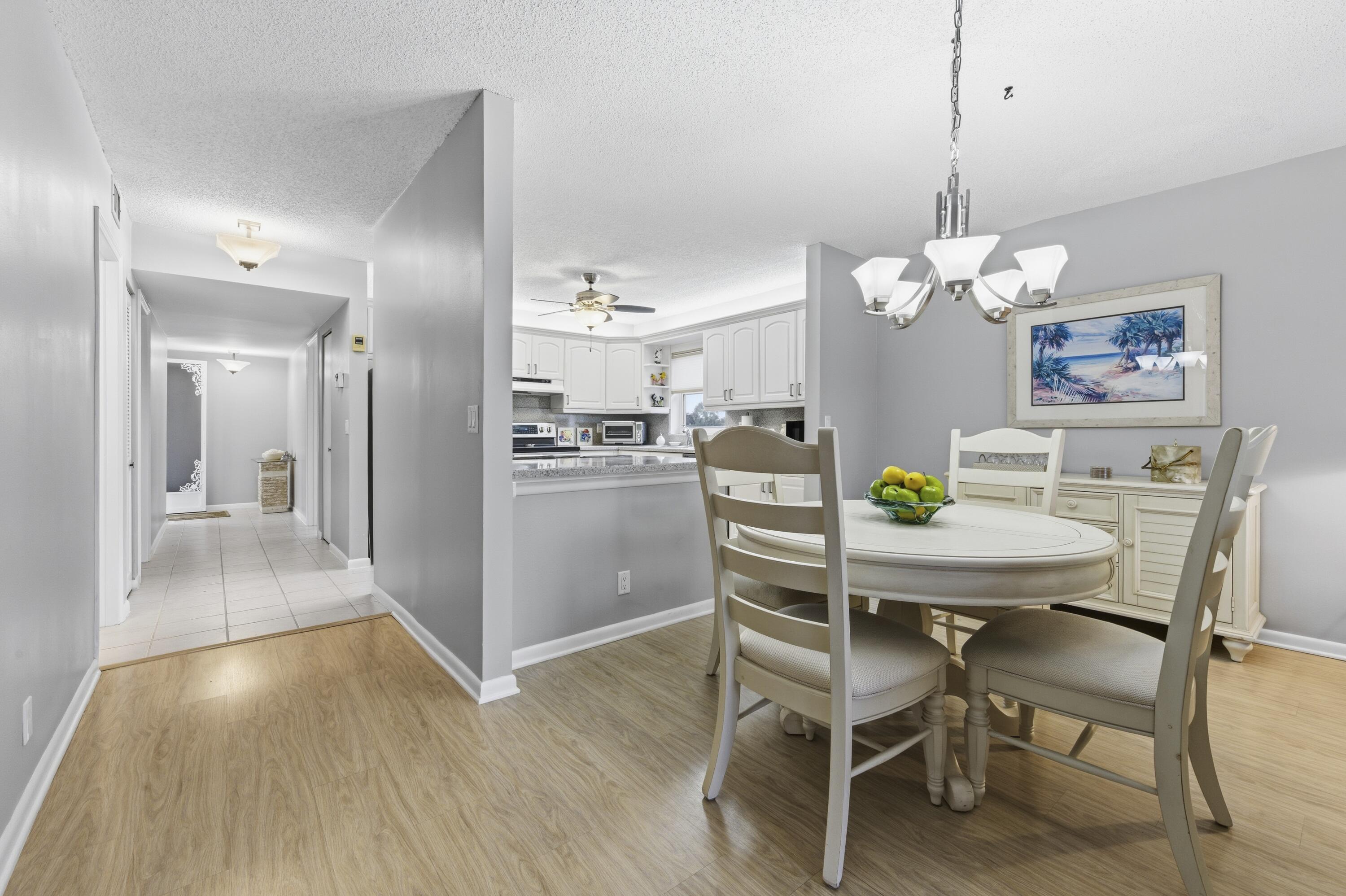 717 Highway 1, Unit 707 Jupiter, FL 33477 - Photo 12 of 33 a view of a dining room with furniture and wooden floor