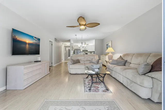 a view of a livingroom with furniture window and wooden floor
