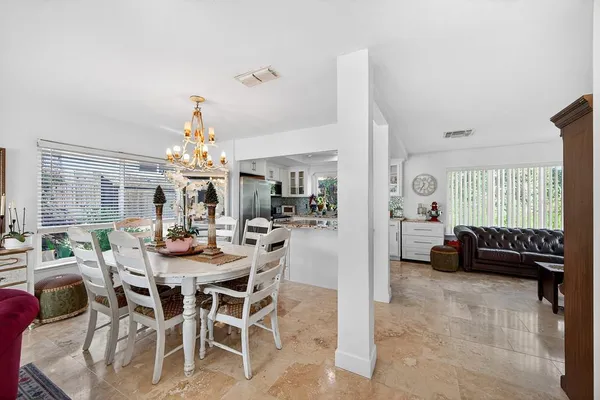 a view of a dining room with furniture and a chandelier