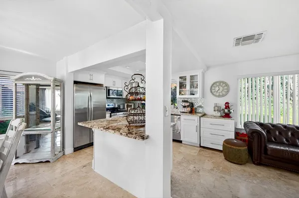 a kitchen with sink cabinets and living room view