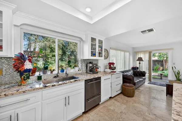 a kitchen with refrigerator and cabinets