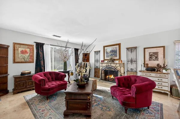 a living room with furniture a couch and a fireplace