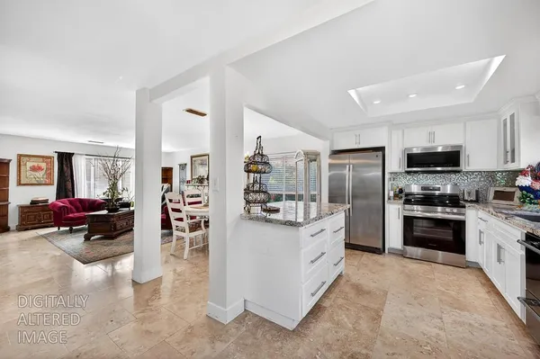 a kitchen with stainless steel appliances granite countertop a stove a sink dishwasher a refrigerator and a microwave oven with wooden floor