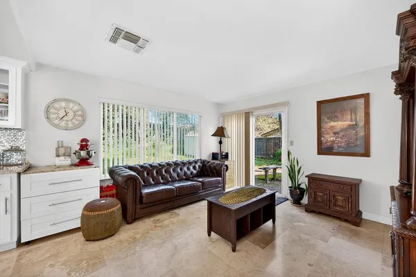 a living room with furniture and a kitchen