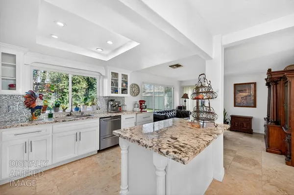 a kitchen with sink stove and refrigerator