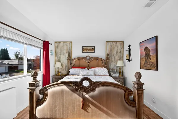 a bed room with a bed and a mirror