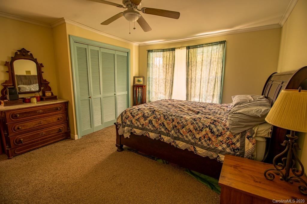 1271 Upper Brush Creek Road Fairview, NC 28730 - Photo 11 of 19 a bedroom with a bed and a dresser
