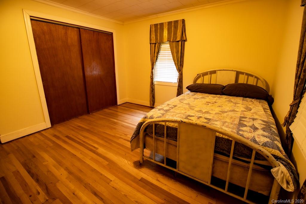 1271 Upper Brush Creek Road Fairview, NC 28730 - Photo 15 of 19 a bedroom with a bed and wooden floor