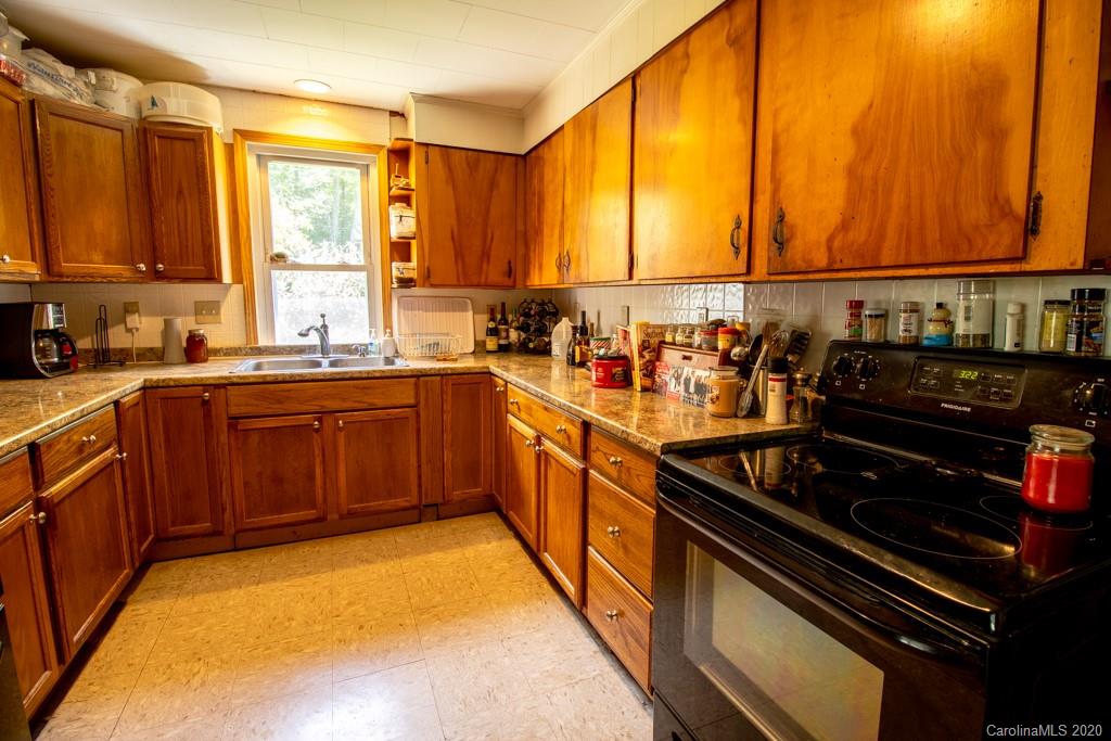 1271 Upper Brush Creek Road Fairview, NC 28730 - Photo 7 of 19 a kitchen with a sink a stove and cabinets