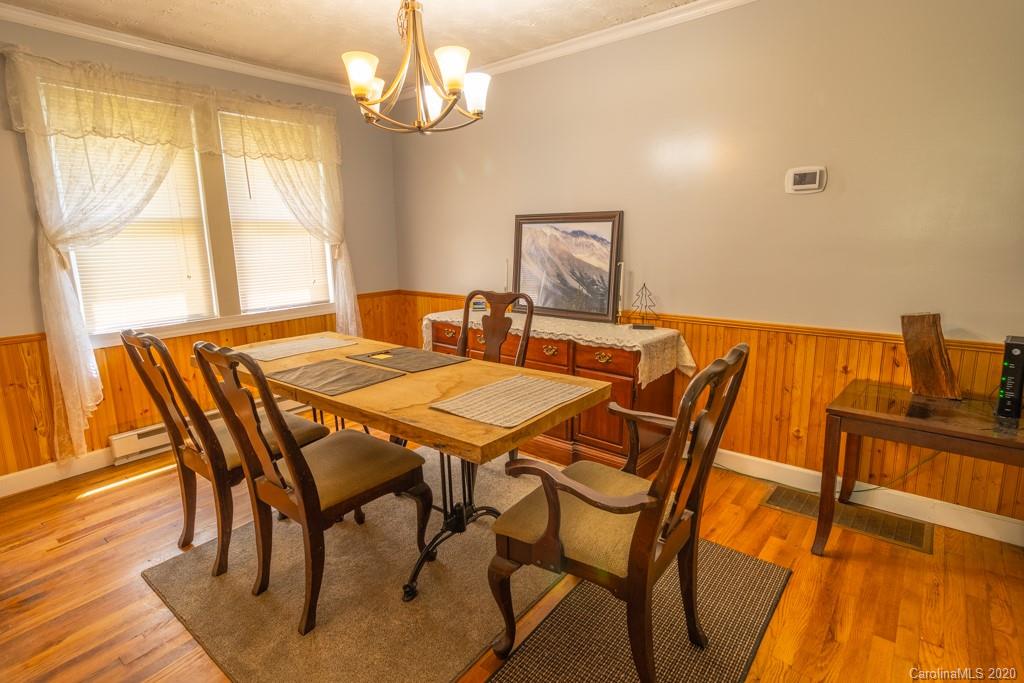 1271 Upper Brush Creek Road Fairview, NC 28730 - Photo 8 of 19 a view of a dining room with furniture wooden floor and chandelier