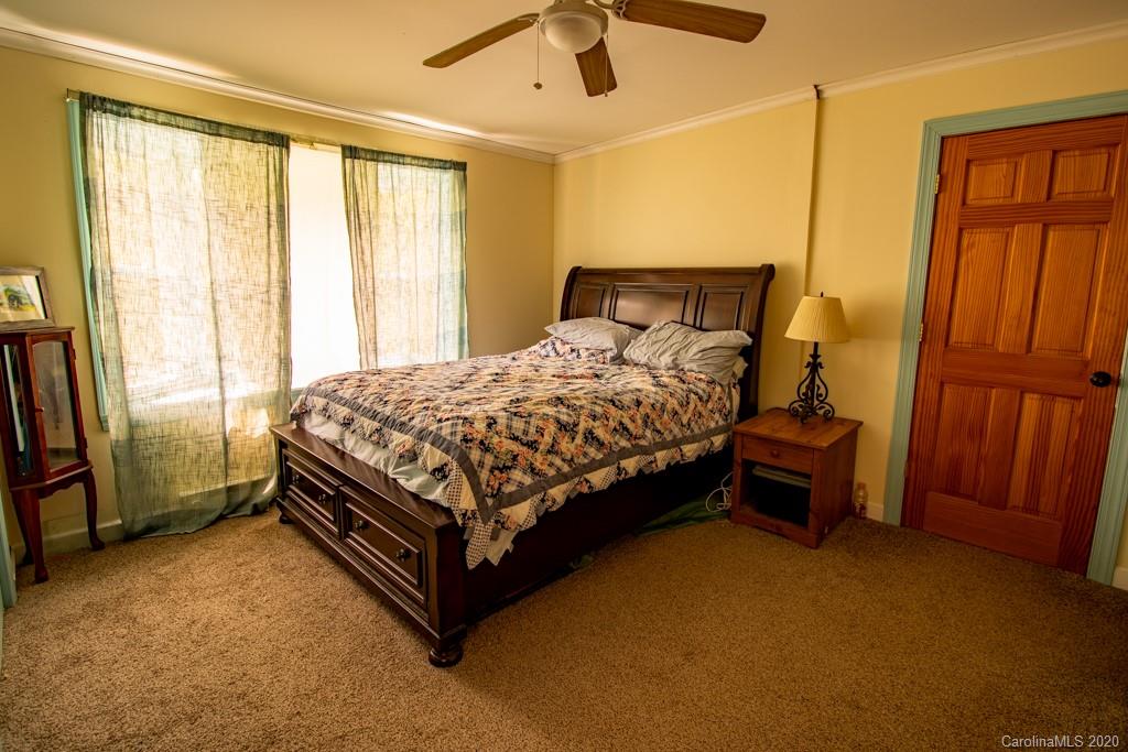 1271 Upper Brush Creek Road Fairview, NC 28730 - Photo 10 of 19 a bedroom with a bed chair and a window