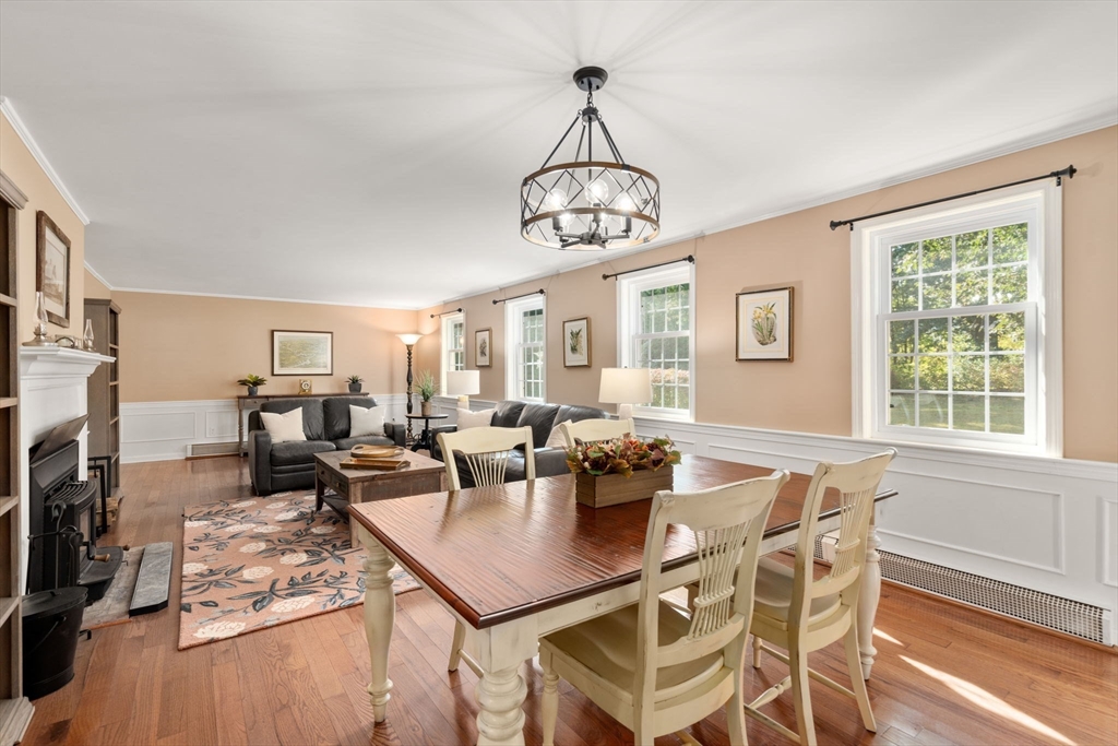216 Old Littleton Road Harvard, MA 01451 - Photo 15 of 34 a view of a dining room with furniture a chandelier and wooden floor