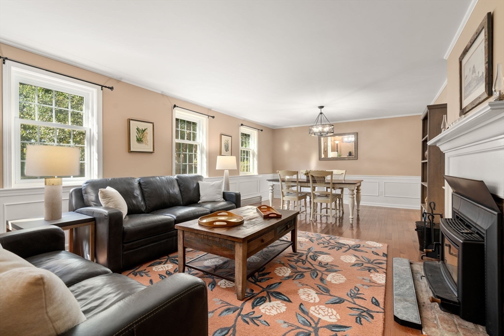 216 Old Littleton Road Harvard, MA 01451 - Photo 16 of 34 a living room with furniture a fireplace and a window