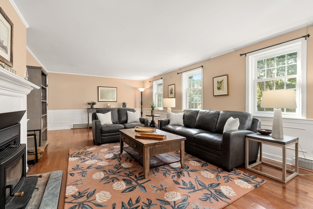 216 Old Littleton Road Harvard, MA 01451 - Photo 17 of 34 a living room with furniture wooden floor and a fireplace