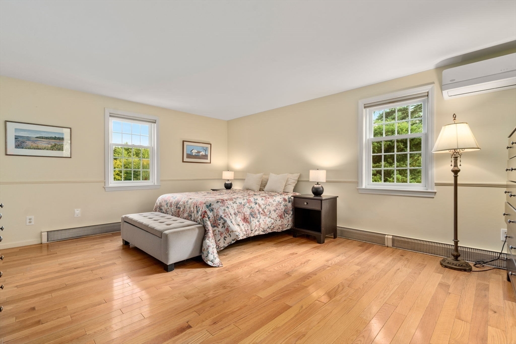 216 Old Littleton Road Harvard, MA 01451 - Photo 19 of 34 a bedroom with a bed lamp on table and a window