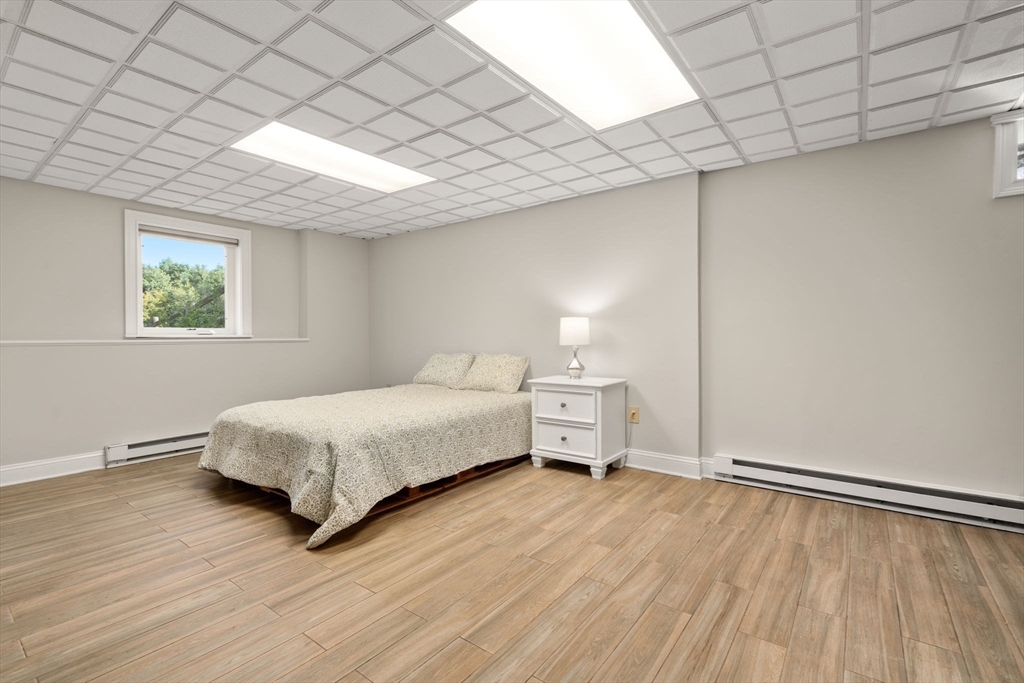 216 Old Littleton Road Harvard, MA 01451 - Photo 30 of 34 a bedroom with a bed and a window