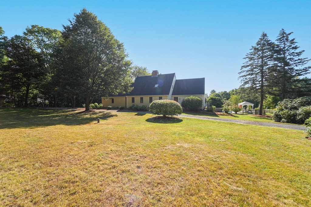 216 Old Littleton Road Harvard, MA 01451 - Photo 3 of 34 a swimming pool with yard and trees in the background