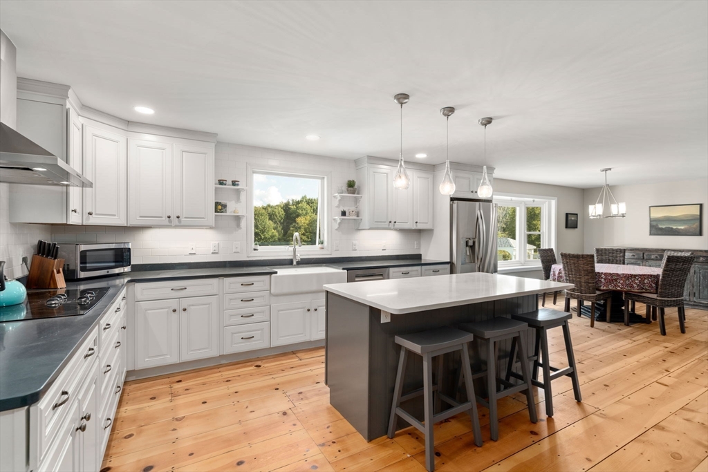 216 Old Littleton Road Harvard, MA 01451 - Photo 9 of 34 a kitchen with kitchen island granite countertop lots of counter top space and sink