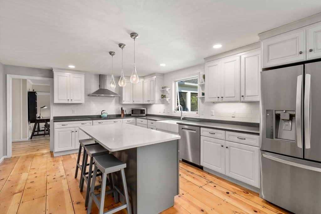 216 Old Littleton Road Harvard, MA 01451 - Photo 10 of 34 a kitchen with stainless steel appliances granite countertop a refrigerator a sink dishwasher a stove and white cabinets with wooden floor