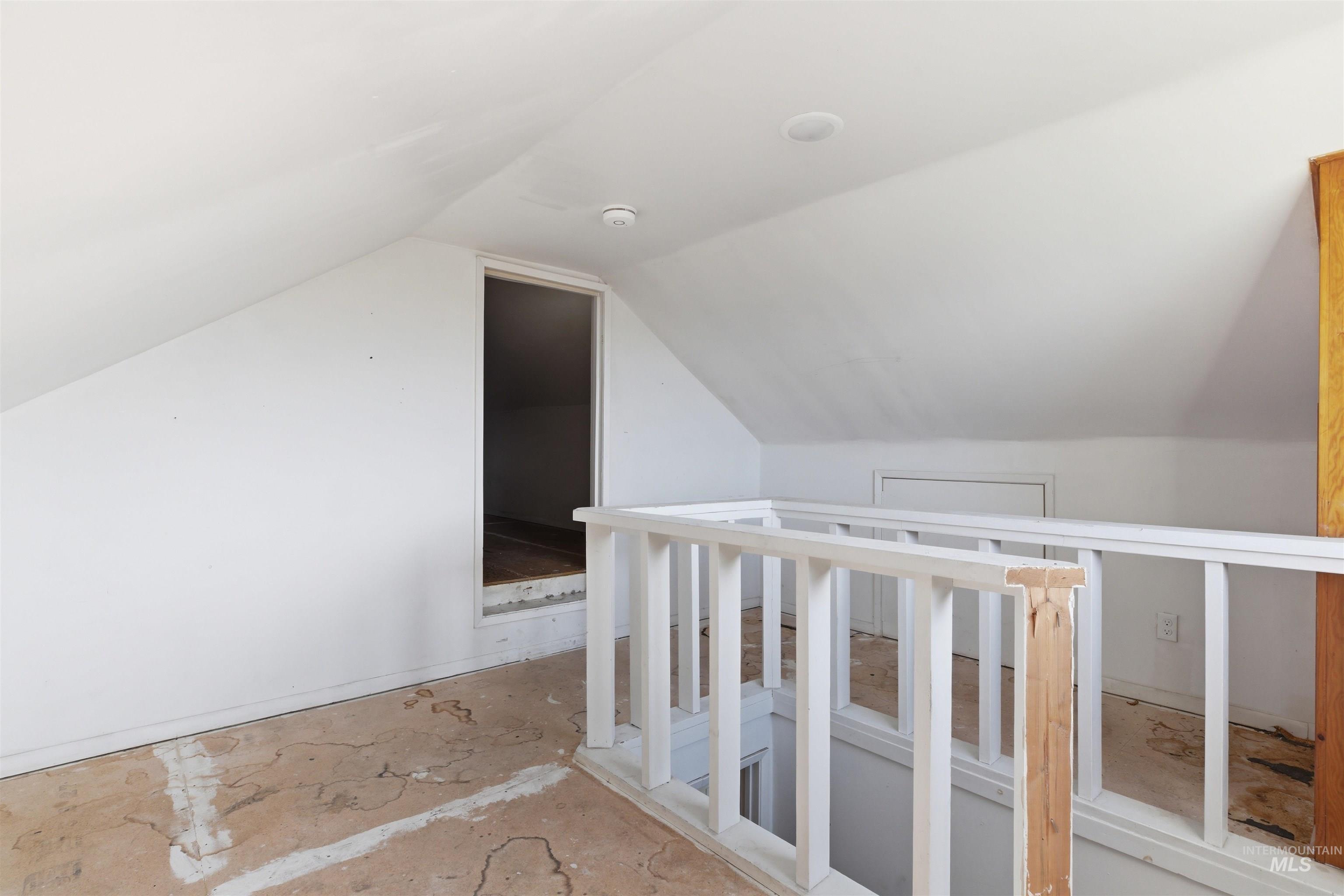 810 Pine Street Potlatch, ID 83855 - Photo 18 of 33 Upper-level loft space featuring a white railing and sloped ceilings