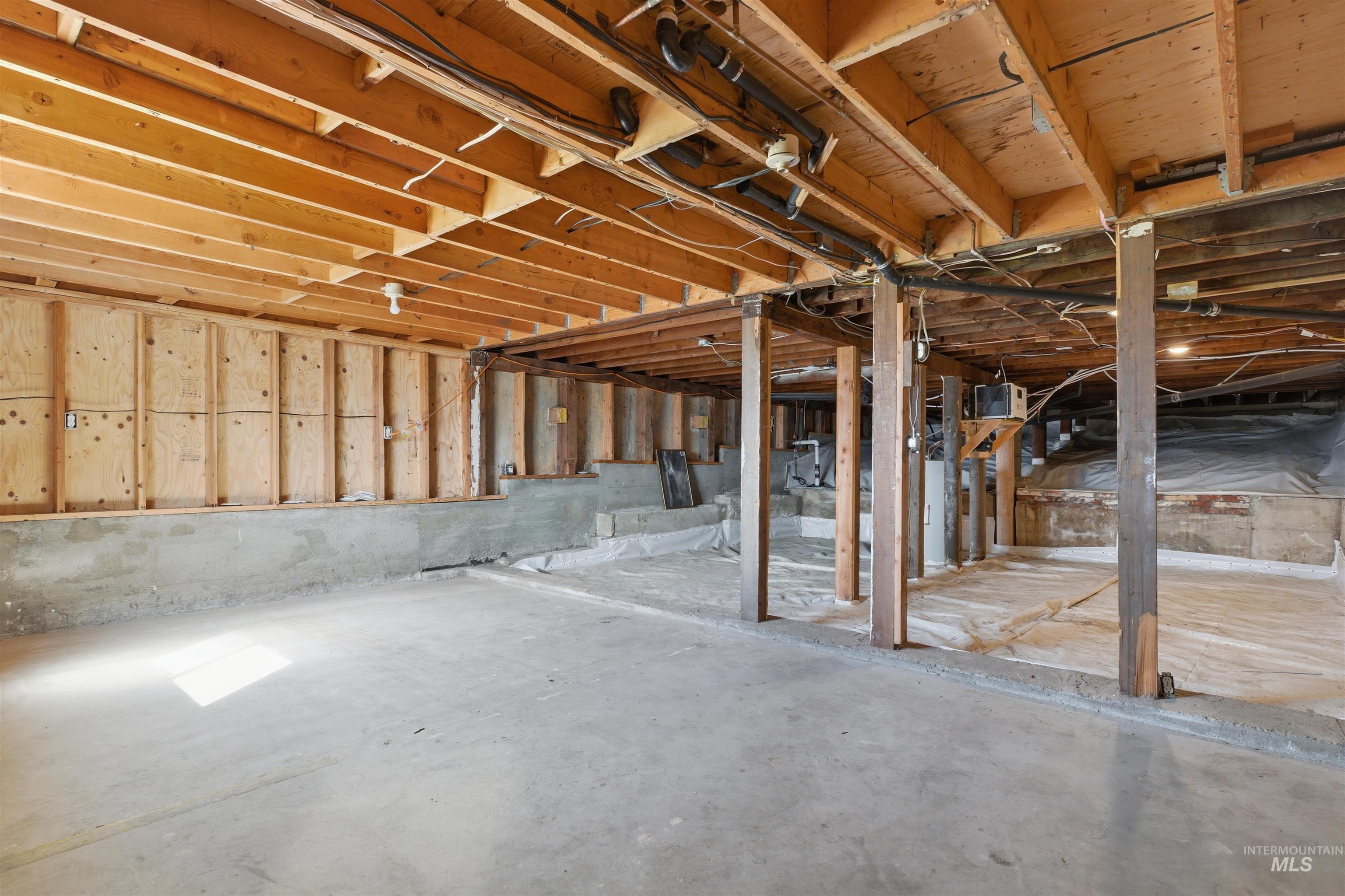 810 Pine Street Potlatch, ID 83855 - Photo 23 of 33 Unfinished basement space featuring exposed wooden joists, concrete flooring, and partial wood framing