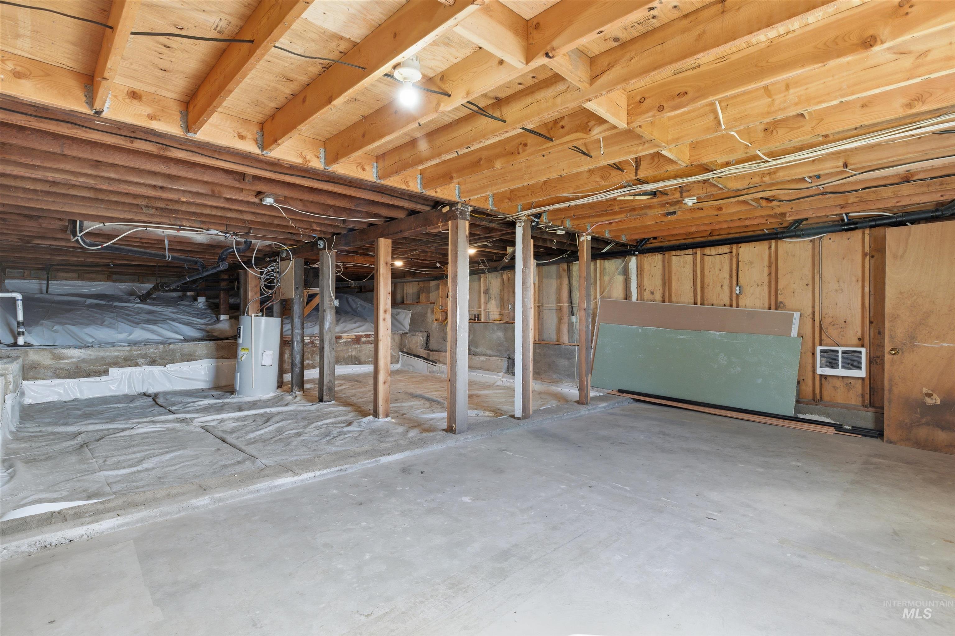 810 Pine Street Potlatch, ID 83855 - Photo 24 of 33 Unfinished basement offering substantial open space, exposed wood joists, a concrete floor, and visible utility infrastructure including a hot water heater