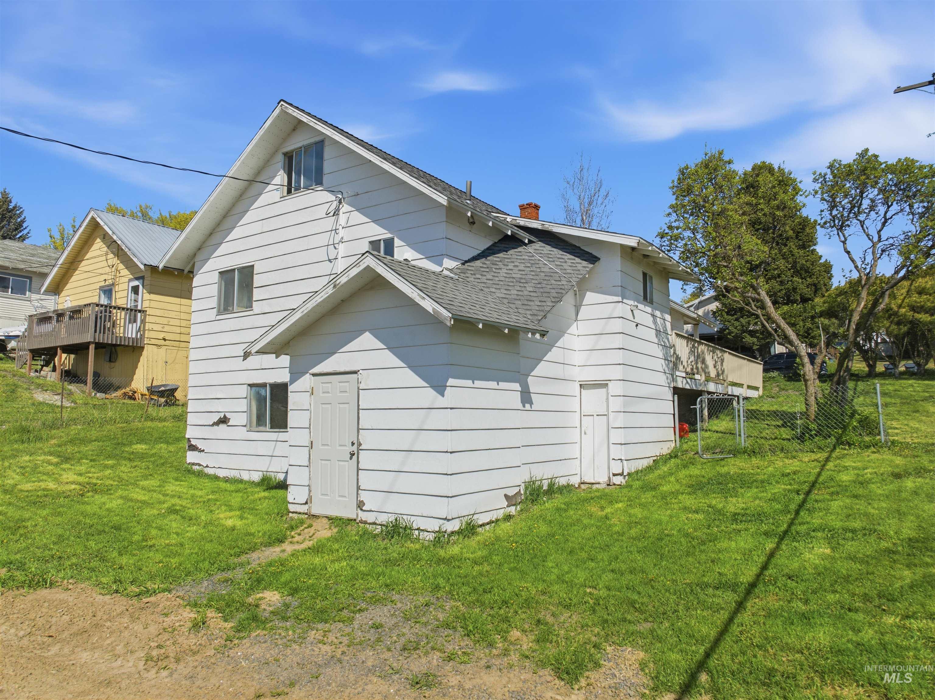 810 Pine Street Potlatch, ID 83855 - Photo 26 of 33 Multi-level residence featuring white siding, a prominent gabled roofline, and multiple windows