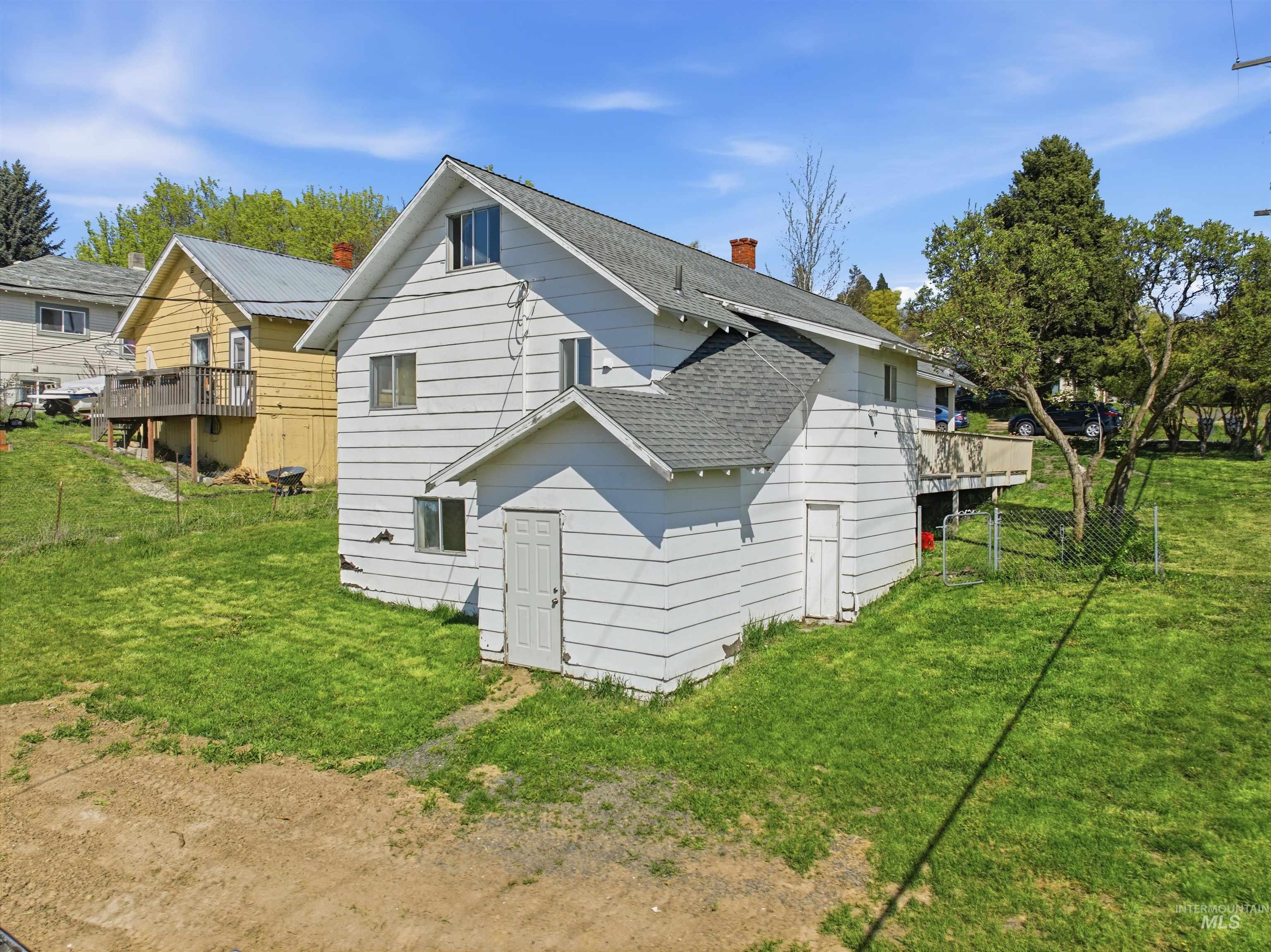 810 Pine Street Potlatch, ID 83855 - Photo 3 of 33 White horizontal siding exterior with a multi-level roofline