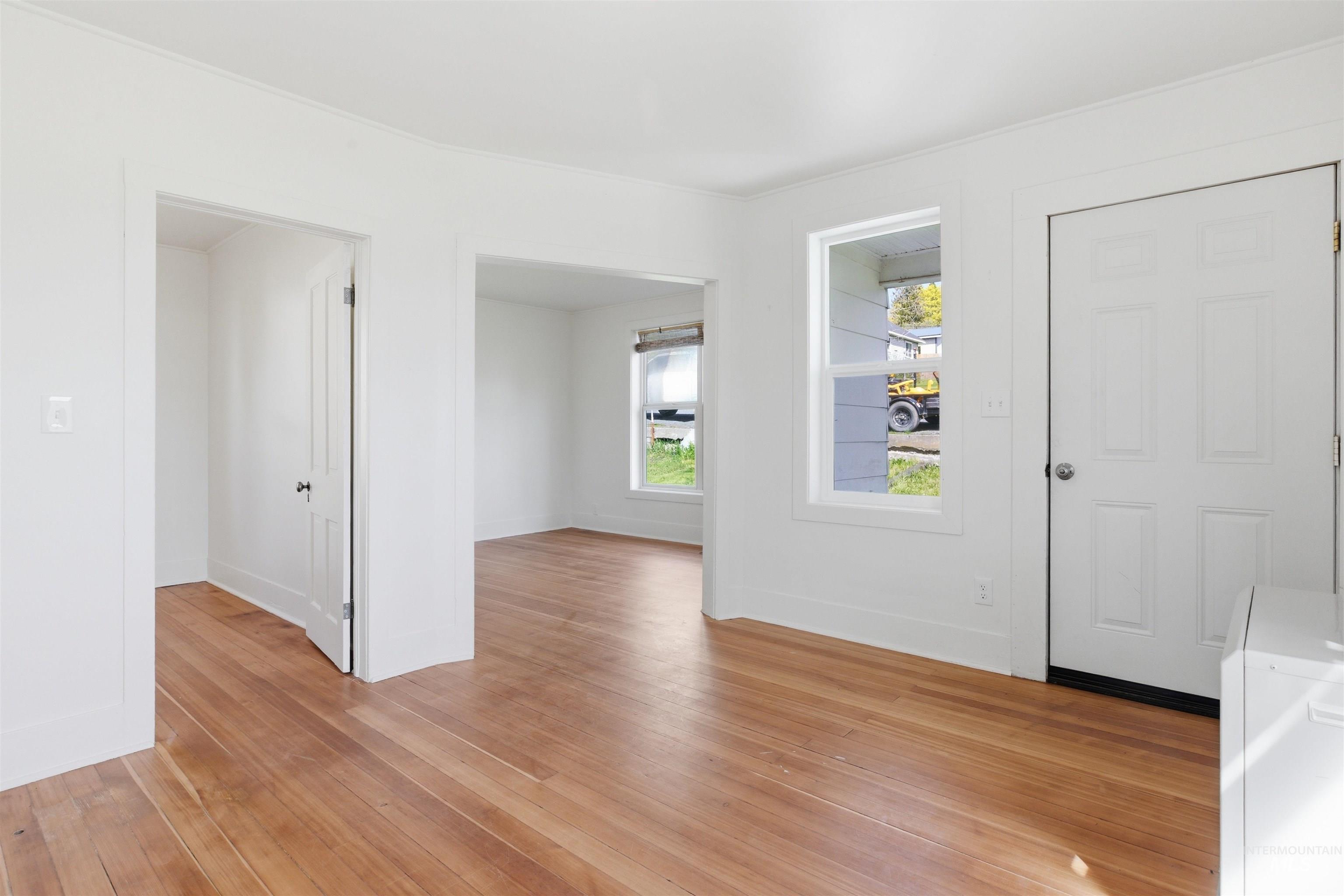 810 Pine Street Potlatch, ID 83855 - Photo 5 of 33 Expansive room featuring wood-finish flooring, white walls, and a white panel door