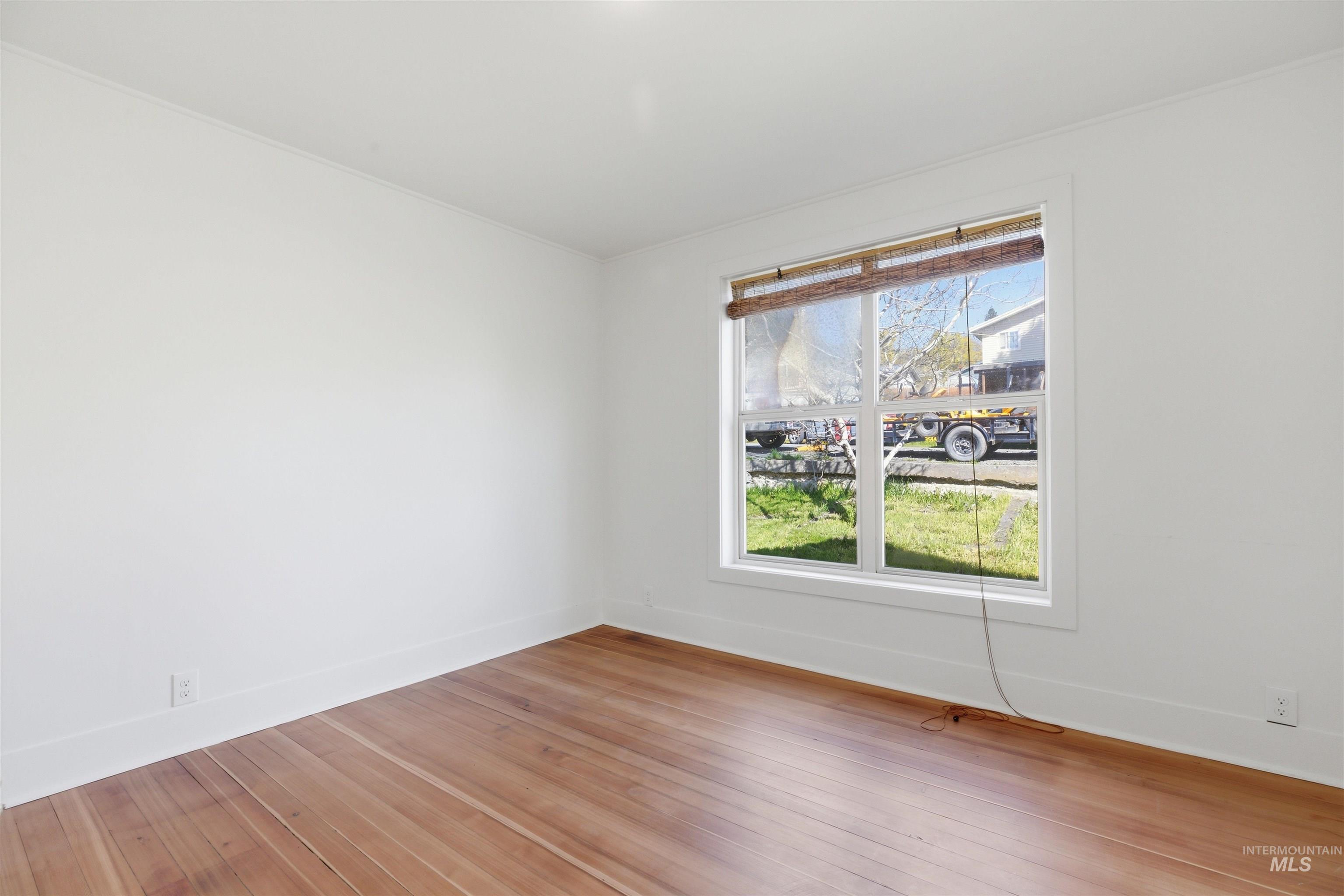 810 Pine Street Potlatch, ID 83855 - Photo 6 of 33 Room featuring wood-finish flooring, white walls, and a window with a bamboo shade