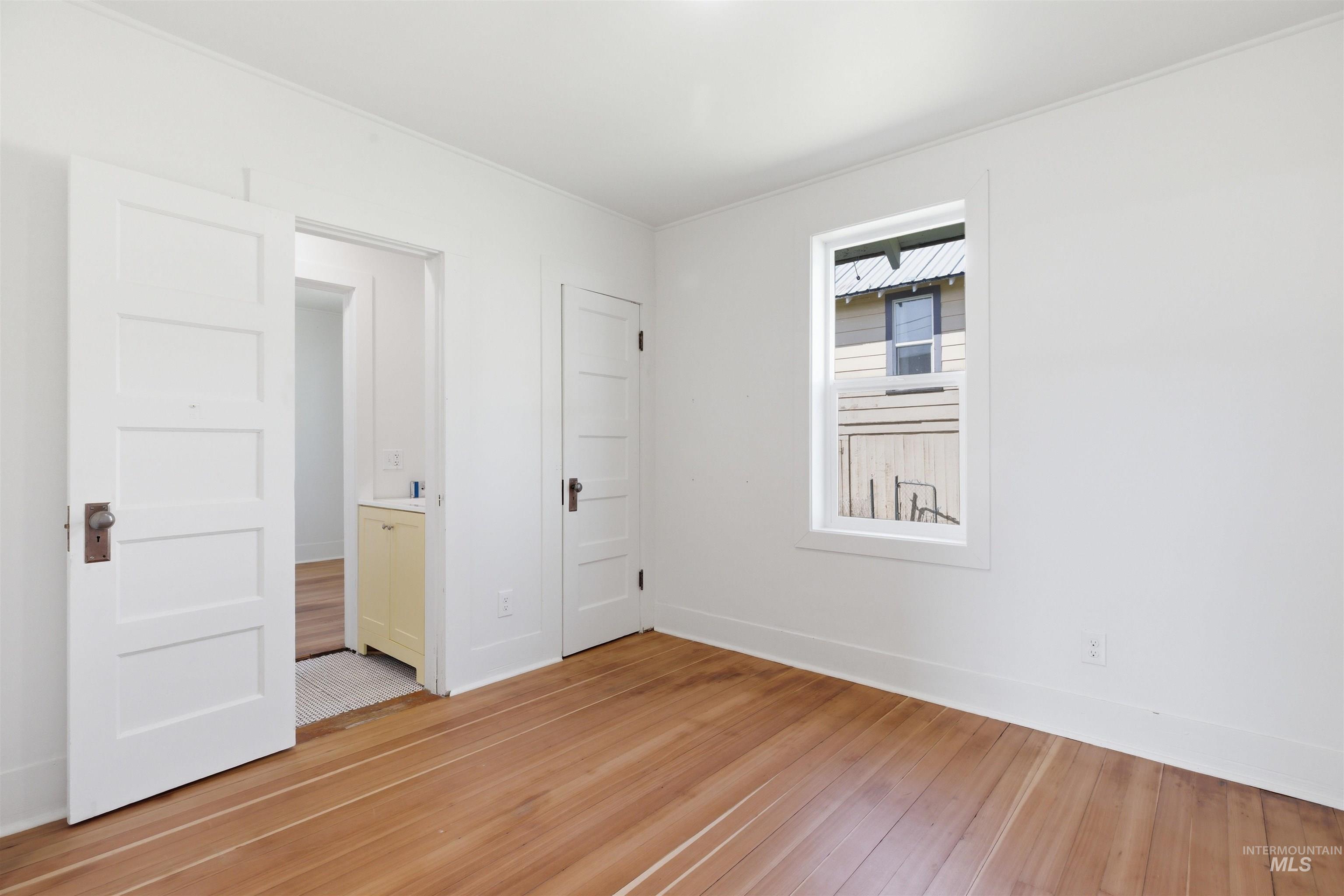 810 Pine Street Potlatch, ID 83855 - Photo 7 of 33 Room featuring wood-finish flooring, white walls, and a single window