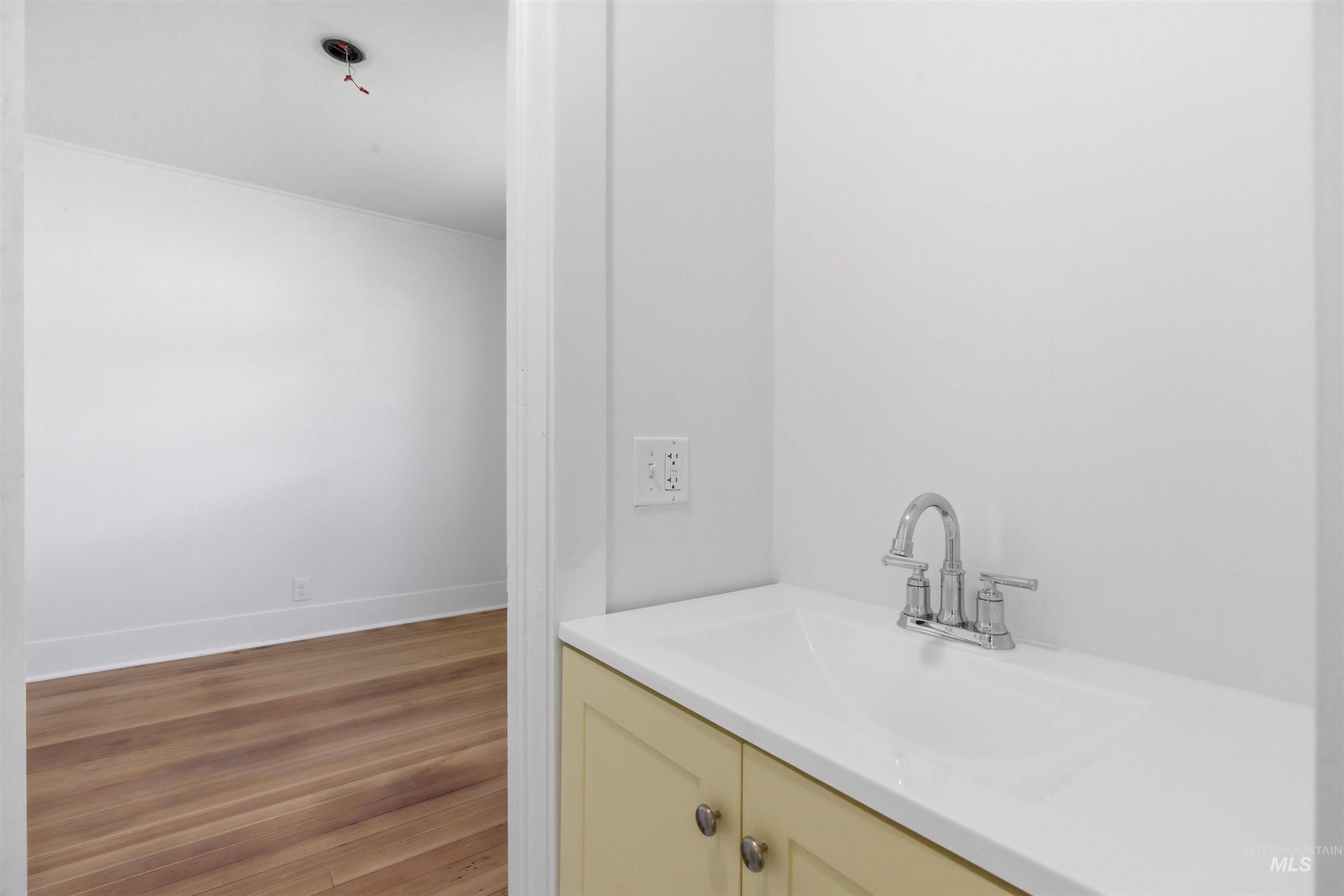 810 Pine Street Potlatch, ID 83855 - Photo 8 of 33 White countertop with an integrated sink and chrome faucet, set atop a light-colored cabinet