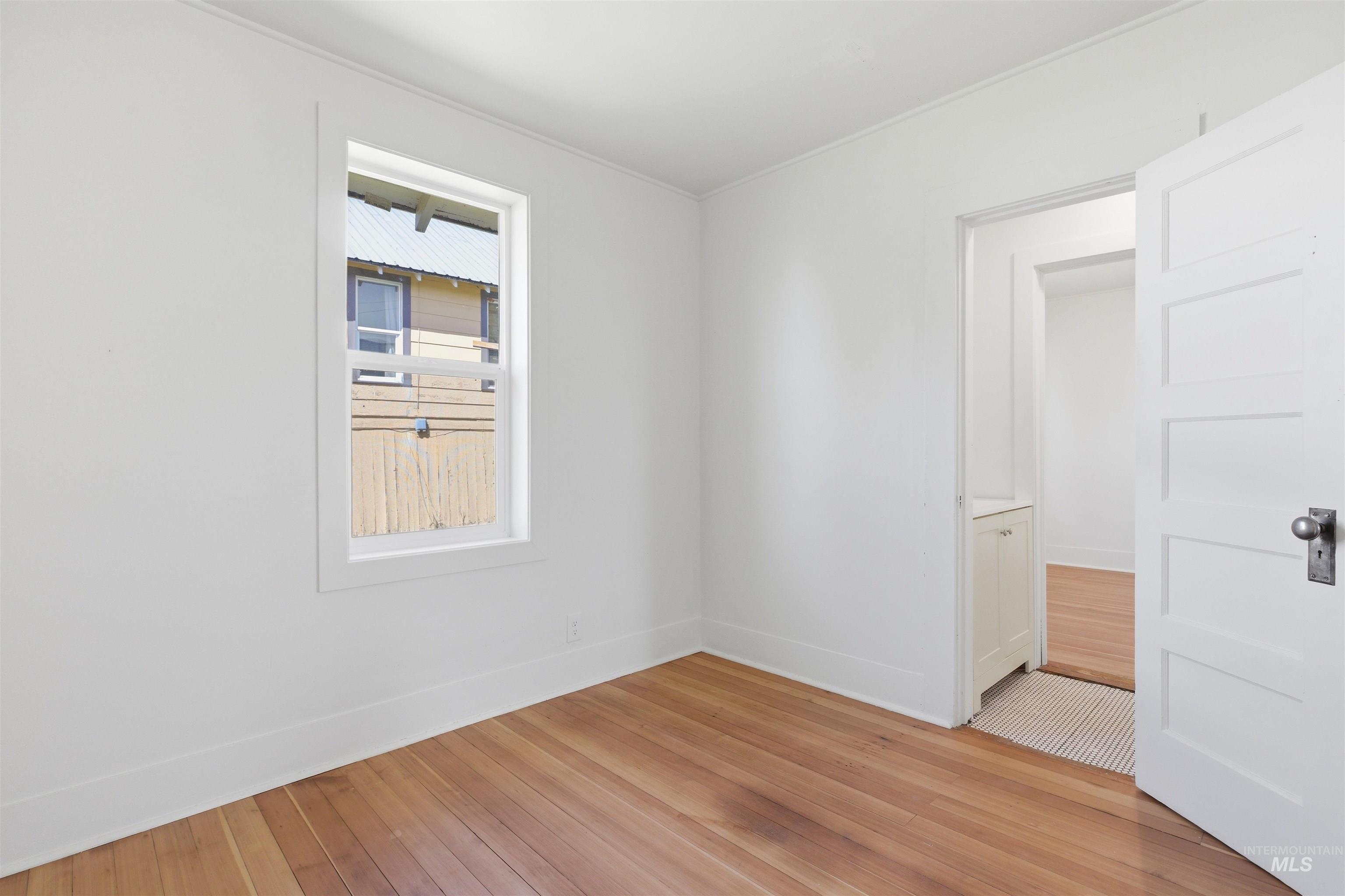 810 Pine Street Potlatch, ID 83855 - Photo 9 of 33 Bright room featuring light wood-finish flooring, white walls, and a white trim window