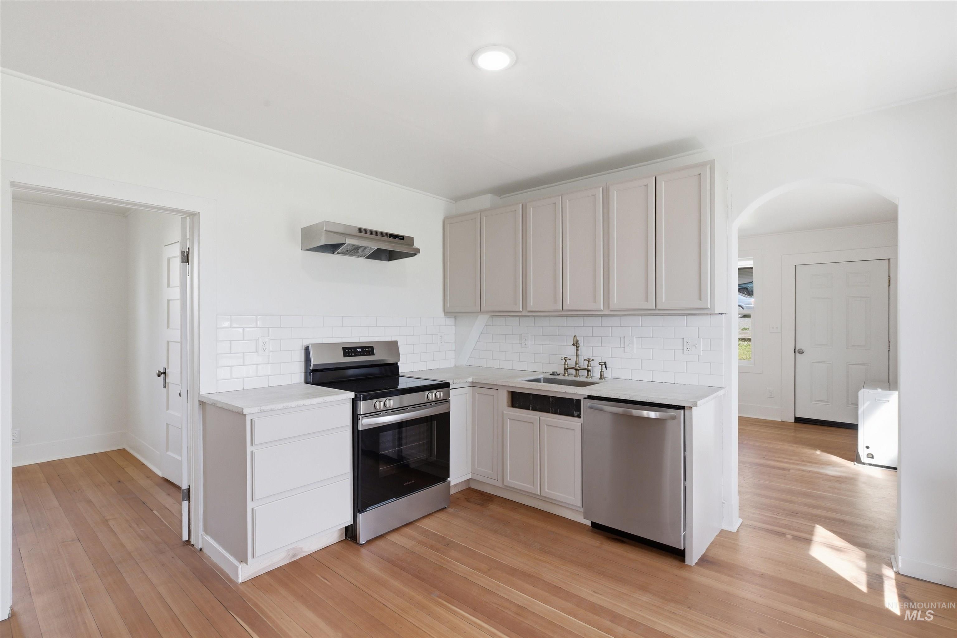 810 Pine Street Potlatch, ID 83855 - Photo 10 of 33 Kitchen featuring light-toned cabinetry, stainless steel appliances, white subway tile backsplash, and light-toned countertops