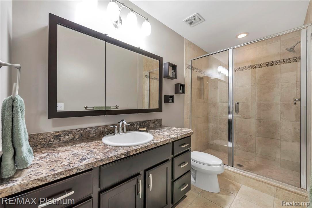 1013 Yarrow Howell, MI 48843 - Photo 16 of 35 Updated En Suite Master Bathroom with Tile Shower, Euro Glass Doors, Ceramic Tile & Elongated Toilets