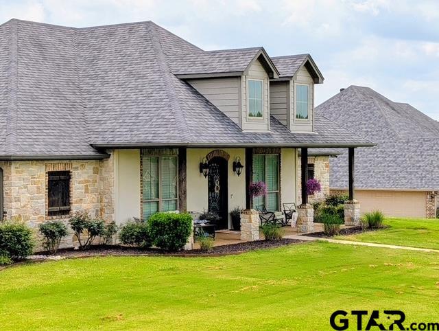 225 Clements Circle Tatum, TX 75691 - Photo 1 of 26 a view of a white house with a swimming pool and a large garden