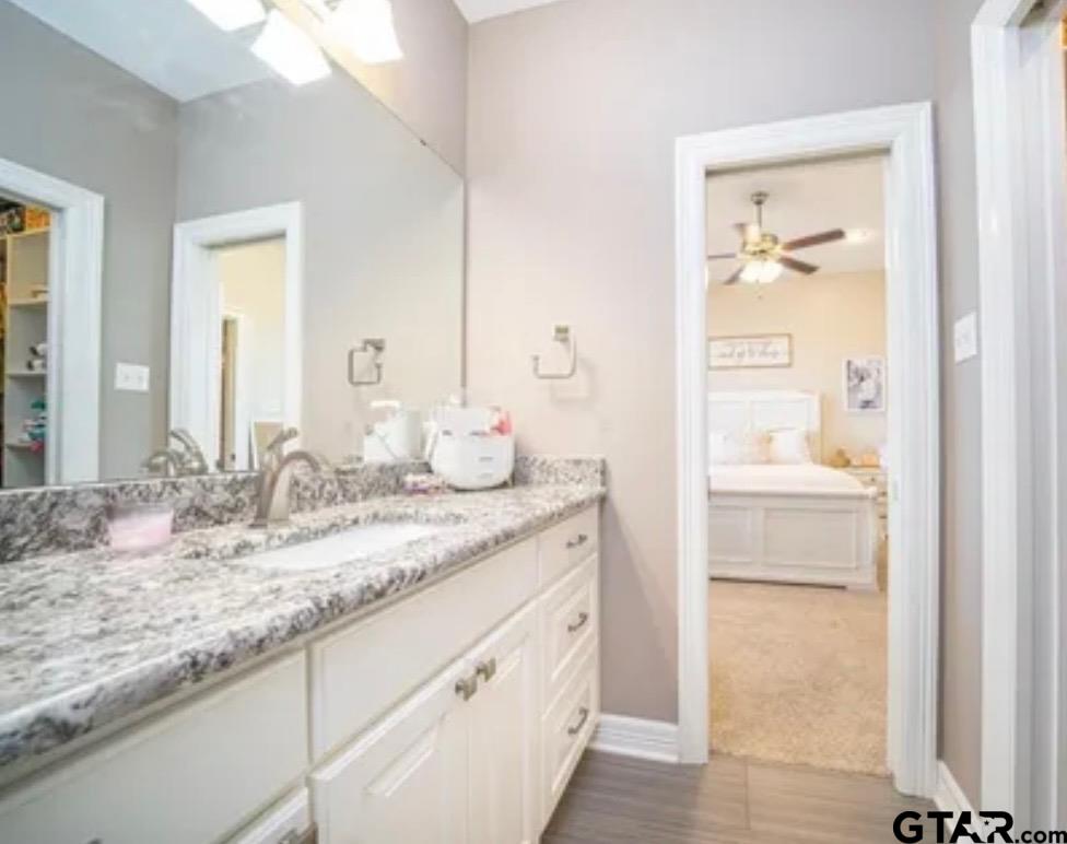 225 Clements Circle Tatum, TX 75691 - Photo 20 of 26 a bathroom with a granite countertop sink and a mirror