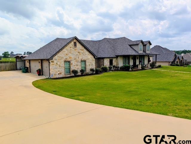 225 Clements Circle Tatum, TX 75691 - Photo 2 of 26 a view of a house with a big yard and potted plants