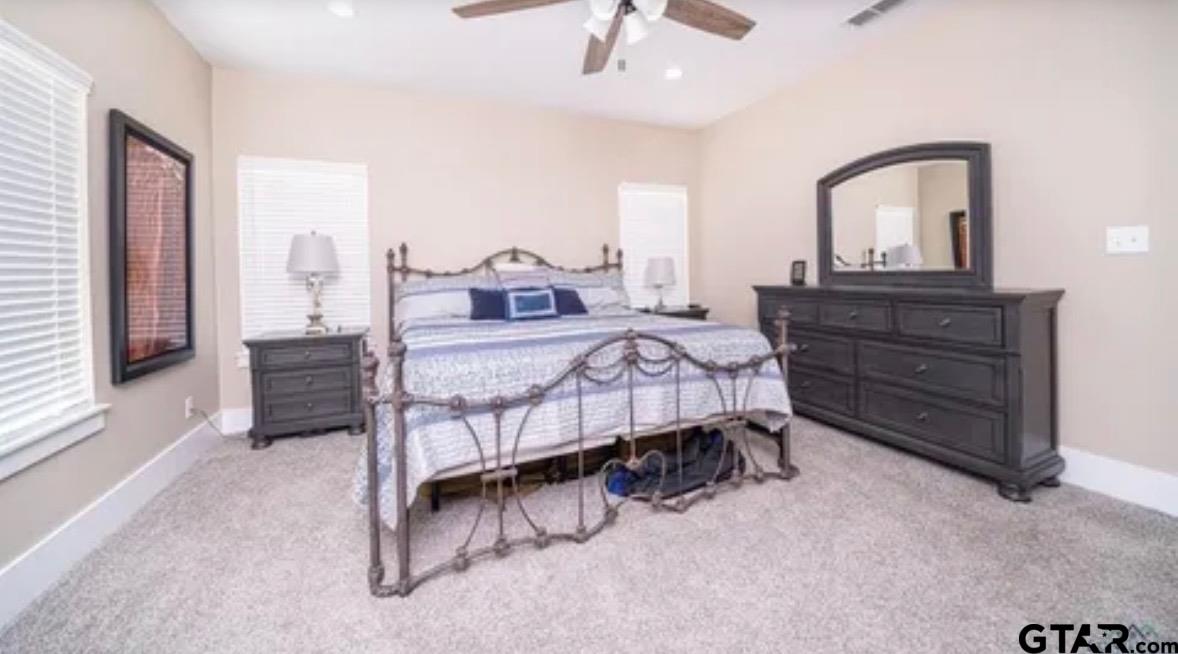 225 Clements Circle Tatum, TX 75691 - Photo 22 of 26 a bedroom with a bed a dresser and with the mirror