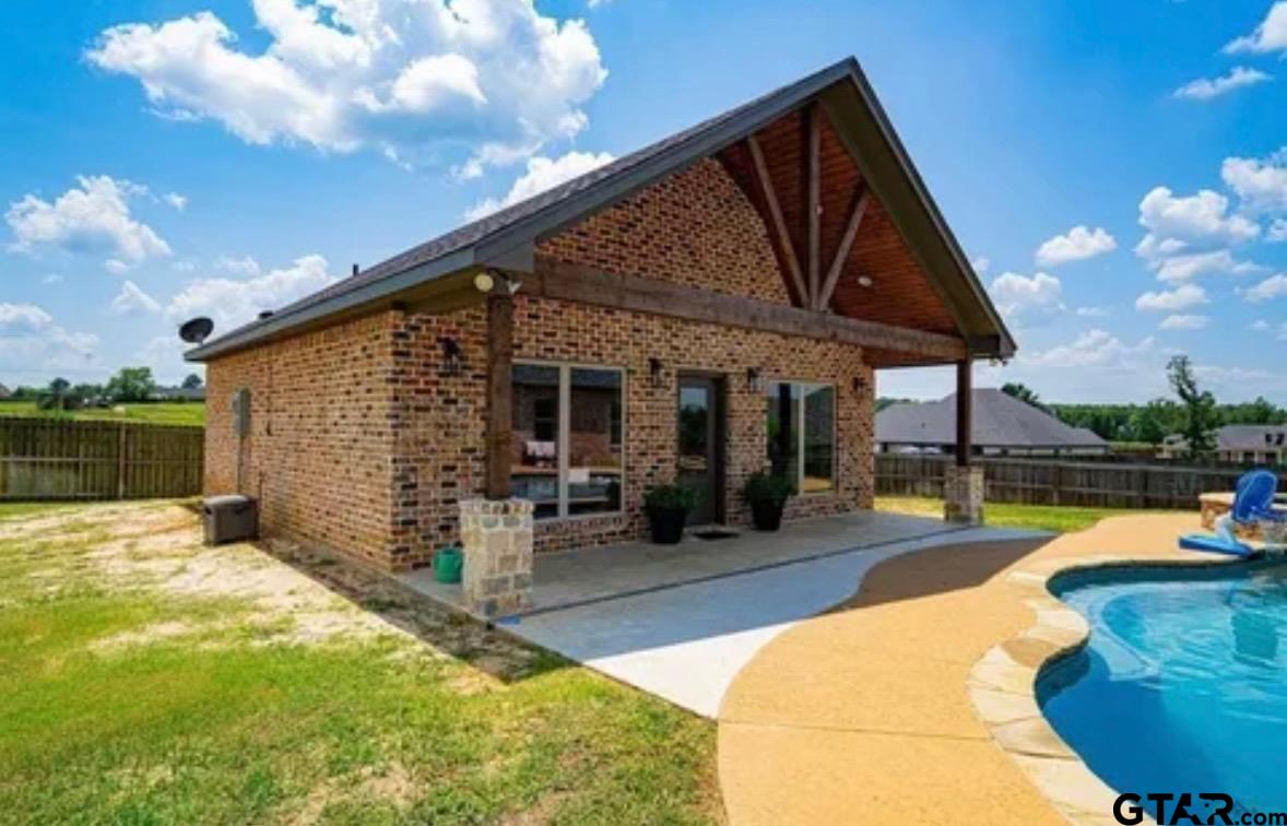 225 Clements Circle Tatum, TX 75691 - Photo 5 of 26 a view of a house with swimming pool and sitting area