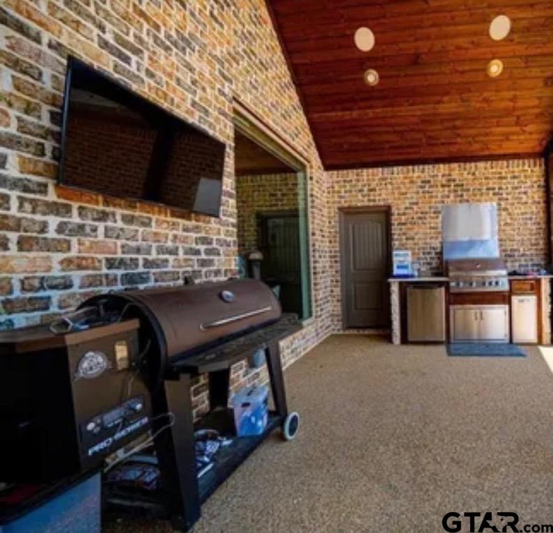 225 Clements Circle Tatum, TX 75691 - Photo 6 of 26 a living room with fireplace furniture and a flat screen tv