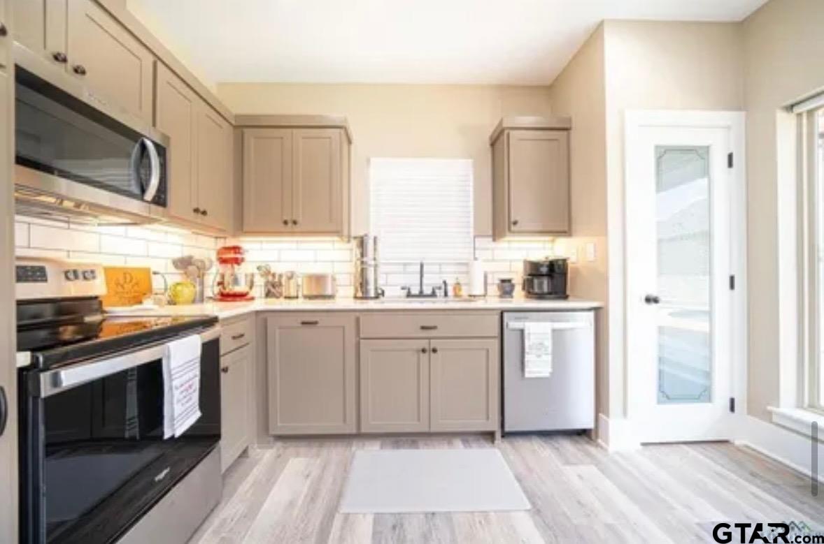 225 Clements Circle Tatum, TX 75691 - Photo 7 of 26 a kitchen with a sink stove and microwave