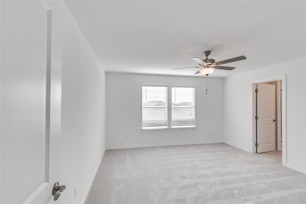 109 Bridge Deck Loop Kyle, TX 78640 - Photo 19 of 40 Empty room with light colored carpet and ceiling fan